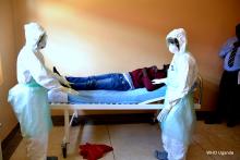 Health workers attend to the suspected Ebola patient at the Ebola ETU in Entebbe