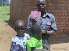 Father after vaccinating his daughters displays a card 