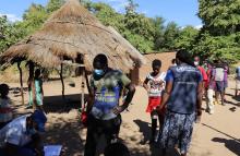             Mathias Nziramasarira (middle) registering his name before he receives medicine