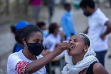 Selamawit gently encourages a woman as she at Yekatit 23 IDP camp in Mekelle